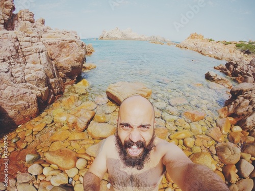 bearded man selfie in a sea landscape in summer photo