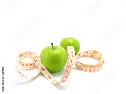 measuring tape wrapped around a green apple for diet