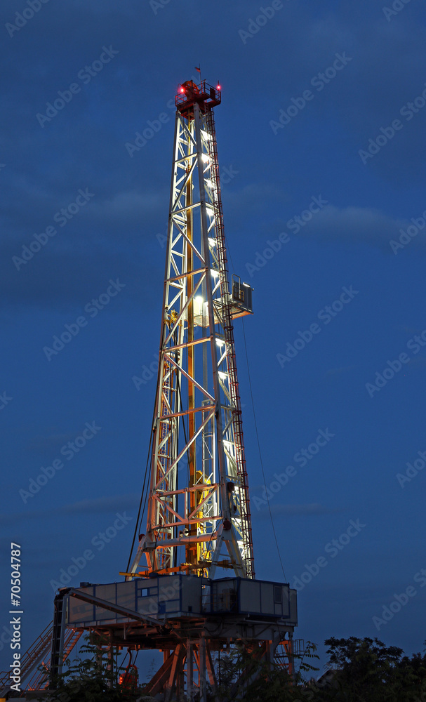 illuminated oil drilling rig on oilfield illuminated oil drilling rig on oilfield