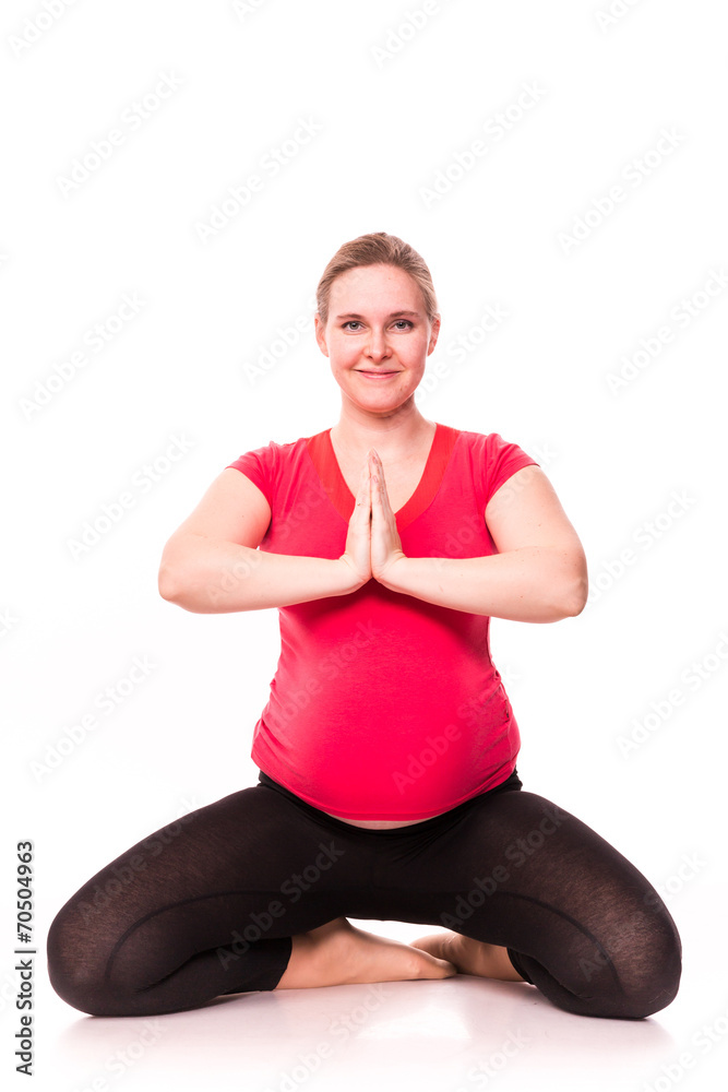 Pregnant woman exercising isolated on white