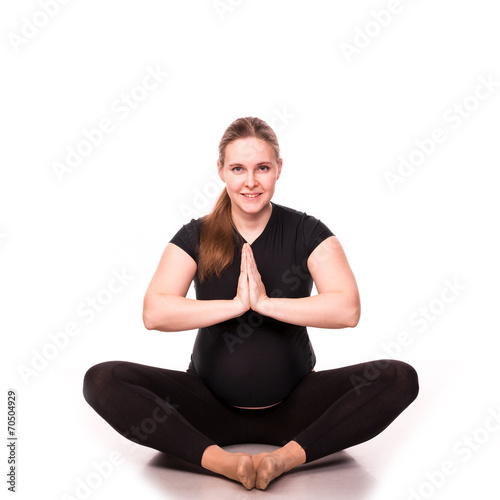 Pregnant woman exercising isolated on white