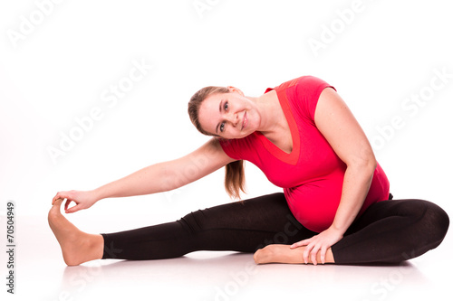 Pregnant woman exercising isolated on white
