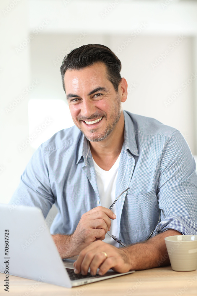 Portrait of mature man working at home with laptop Portrait of mature man working at home with laptop