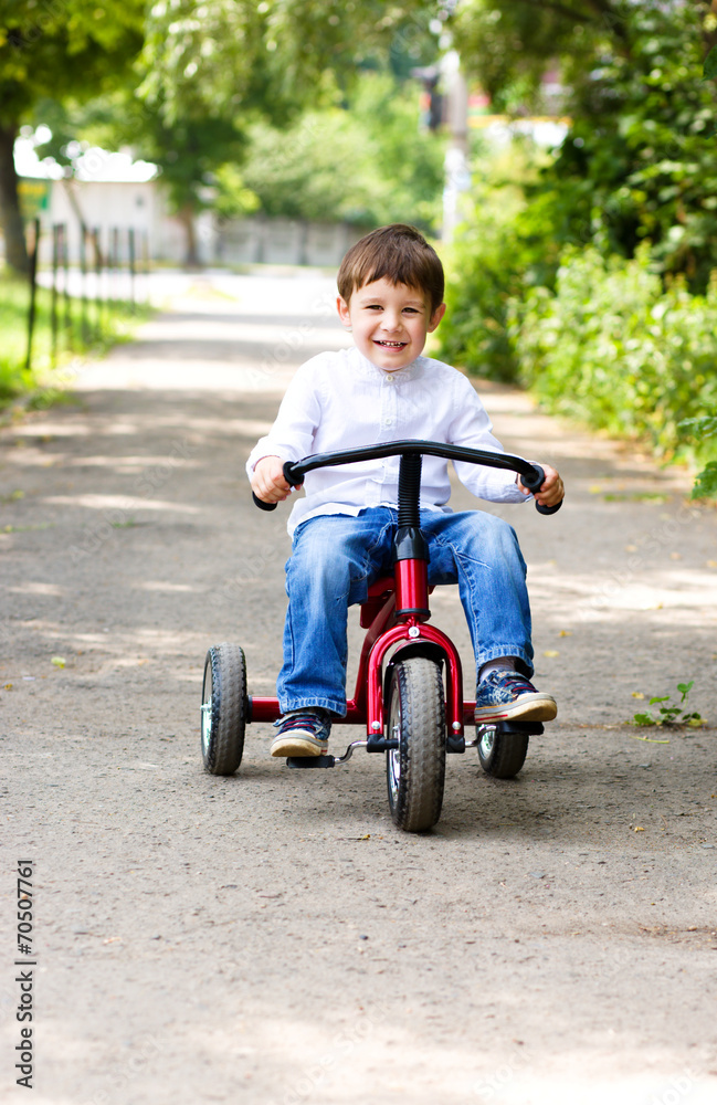 Boy riding a bicycle in the park Boy riding a bicycle in the park