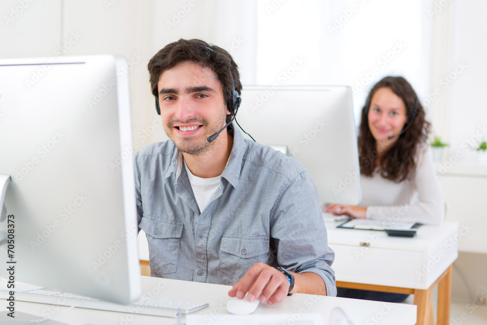 Young attractive man working in a call center Young attractive man working in a call center