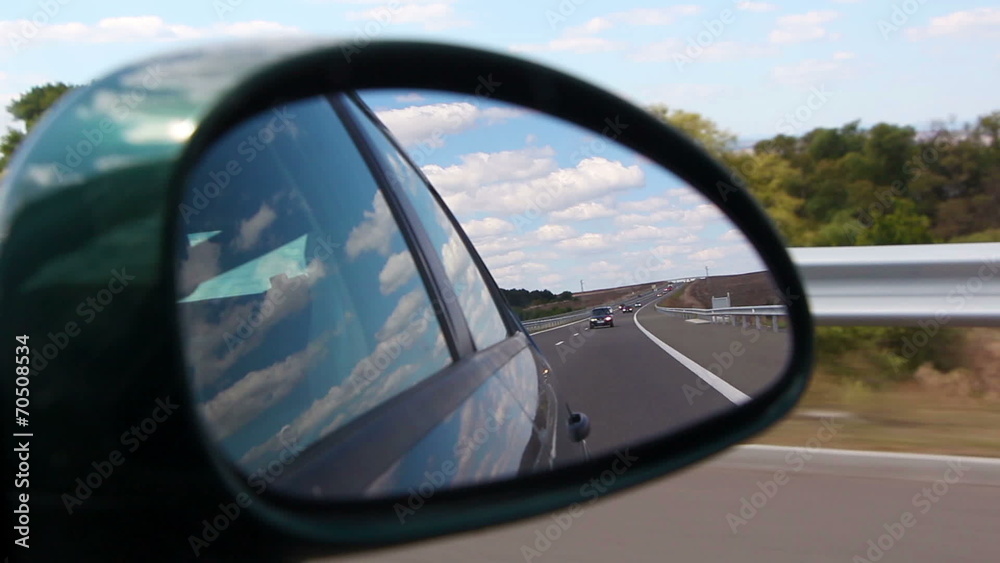 Highway view on side mirror of a car Highway view on side mirror of a car