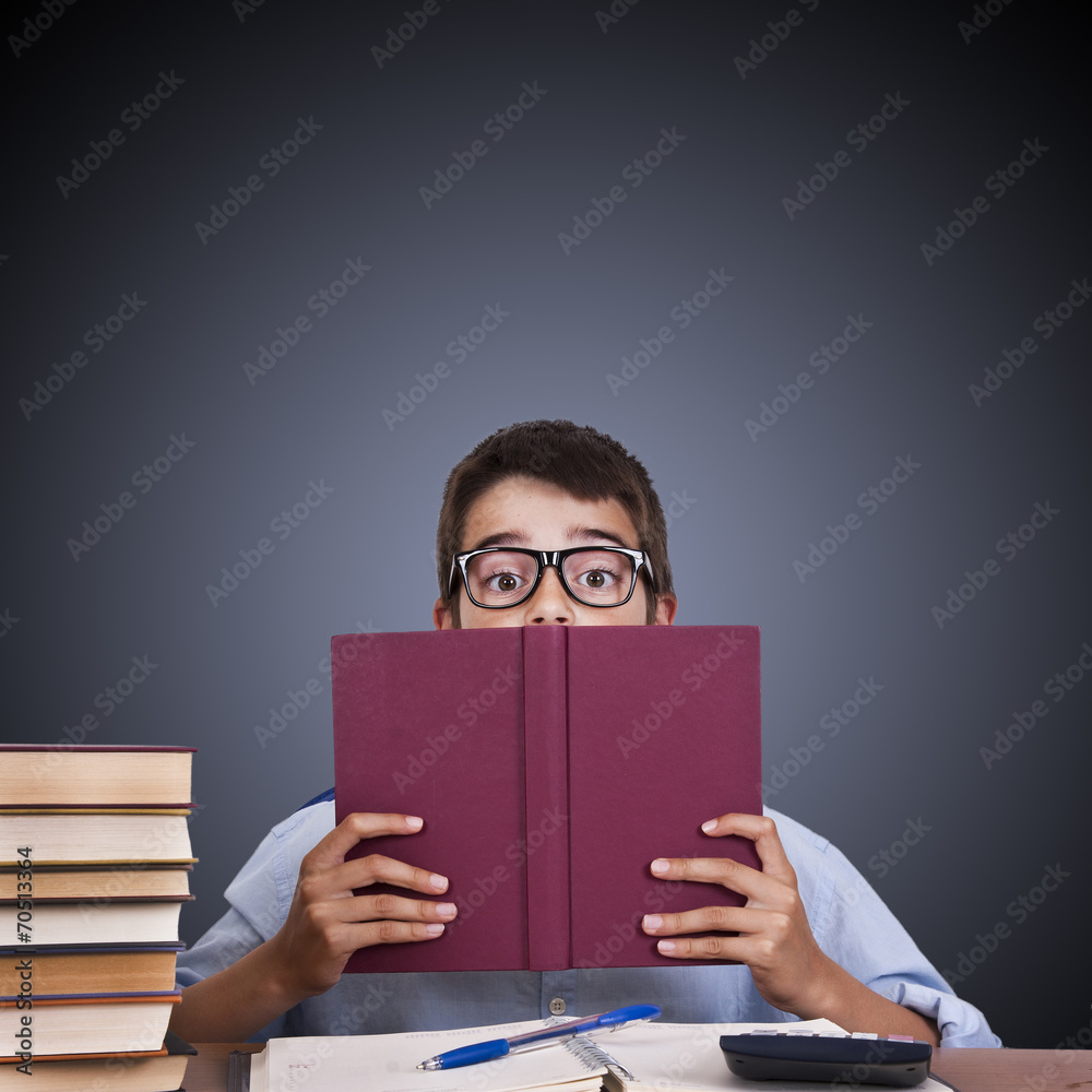 child at the table with books from school child at the table with books from school