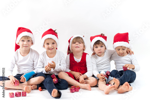 Adorable kids with santas hat, smiling at the camera