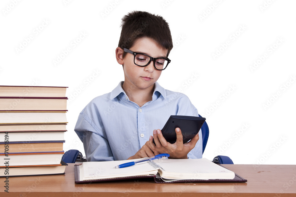 child at the table with books from school child at the table with books from school