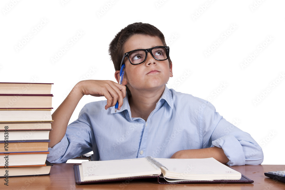 child at the table with books from school
