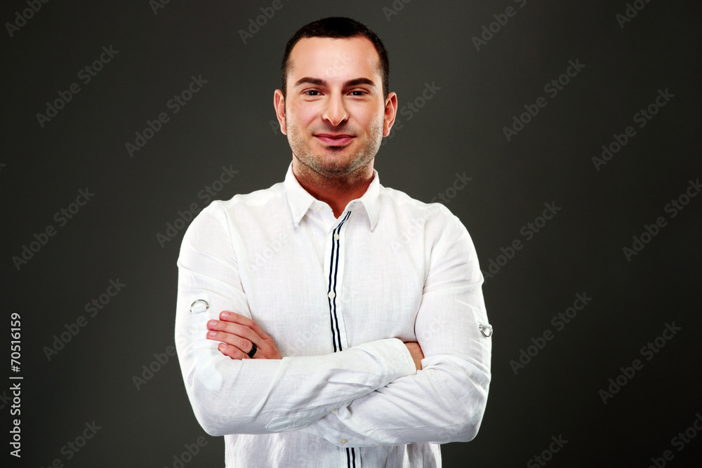 Portrait of smiling businessman standing with arms folded Portrait of smiling businessman standing with arms folded