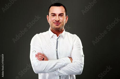 Portrait of smiling businessman standing with arms folded © Drobot Dean