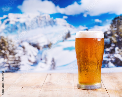 glass of beer over winter landscape