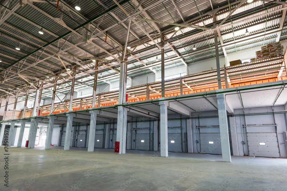 Big automated warehouse, panorama of mezzanine and loading gates or docks, industry concept - obrazy, fototapety, plakaty 