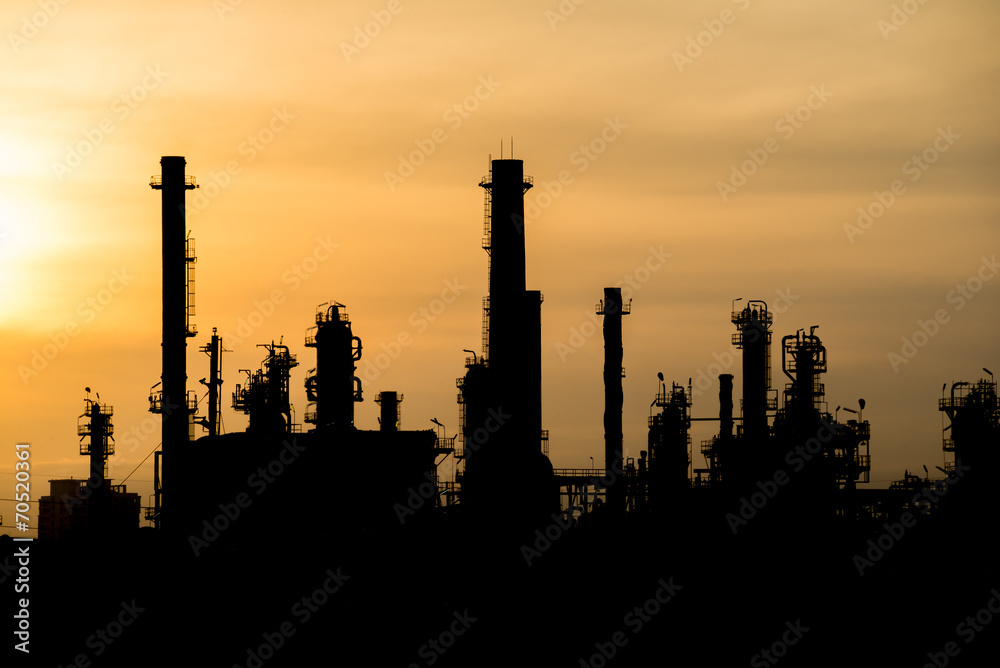 silhouette tower of oil refinery at sunrise