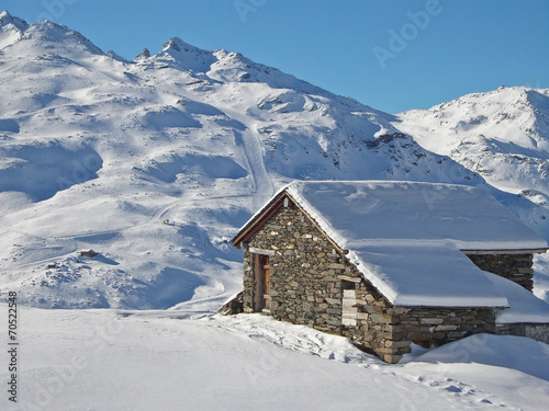 Cabin in the Alps in winter, snowy landscape