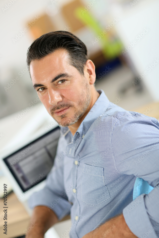 Businessman sitting in office and working on laptop Businessman sitting in office and working on laptop