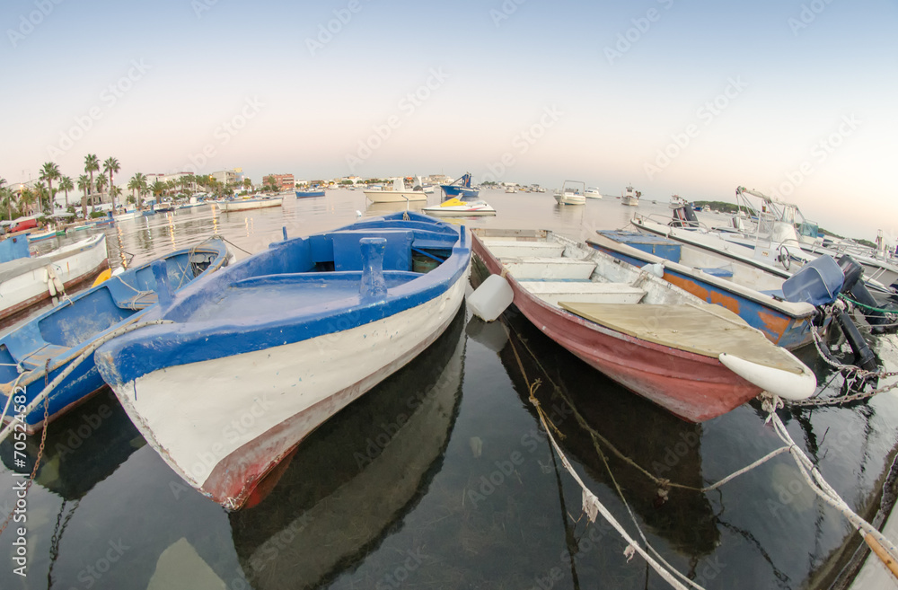 Old wooden boats anchored in a small port