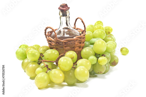 Old sealed bottle of wine and white grape isolated on white