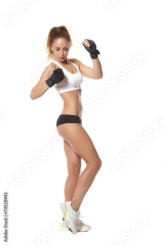  young fit woman lifting dumbbells on white background
