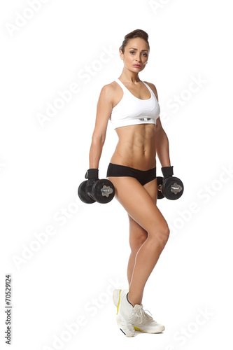  young fit woman lifting dumbbells on white background