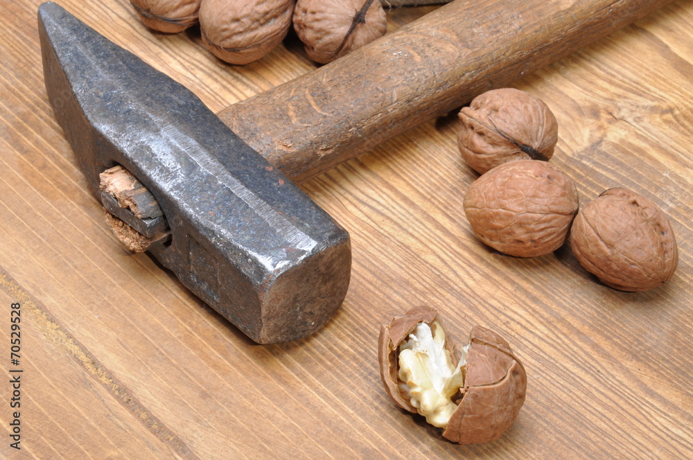 Walnuts and hammer n the table Walnuts and hammer n the table