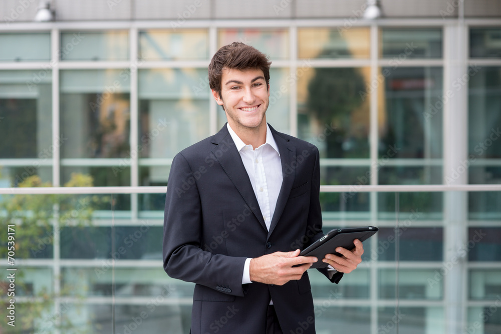 Young business man smiling with tablet Young business man smiling with tablet