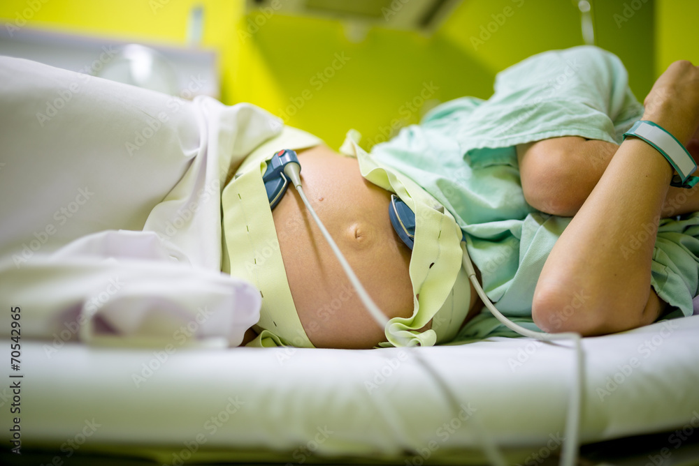 Pregnant woman undergoing cardiotocography - obrazy, fototapety, plakaty 