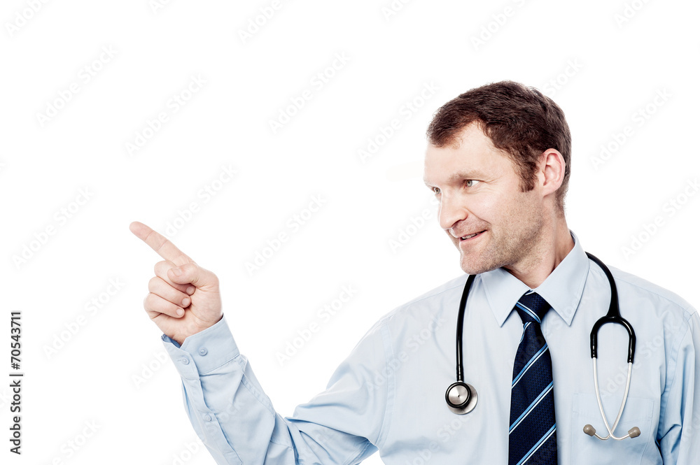 Male physician pointing his finger right Male physician pointing his finger right