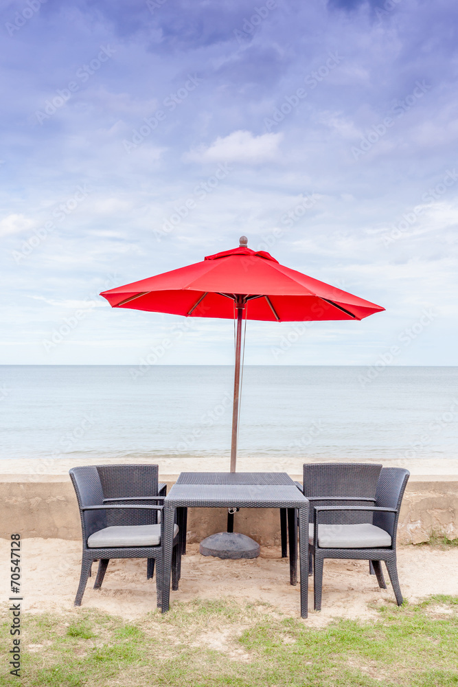 Outdoor table set, beach chairs and red umbrella with beautiful