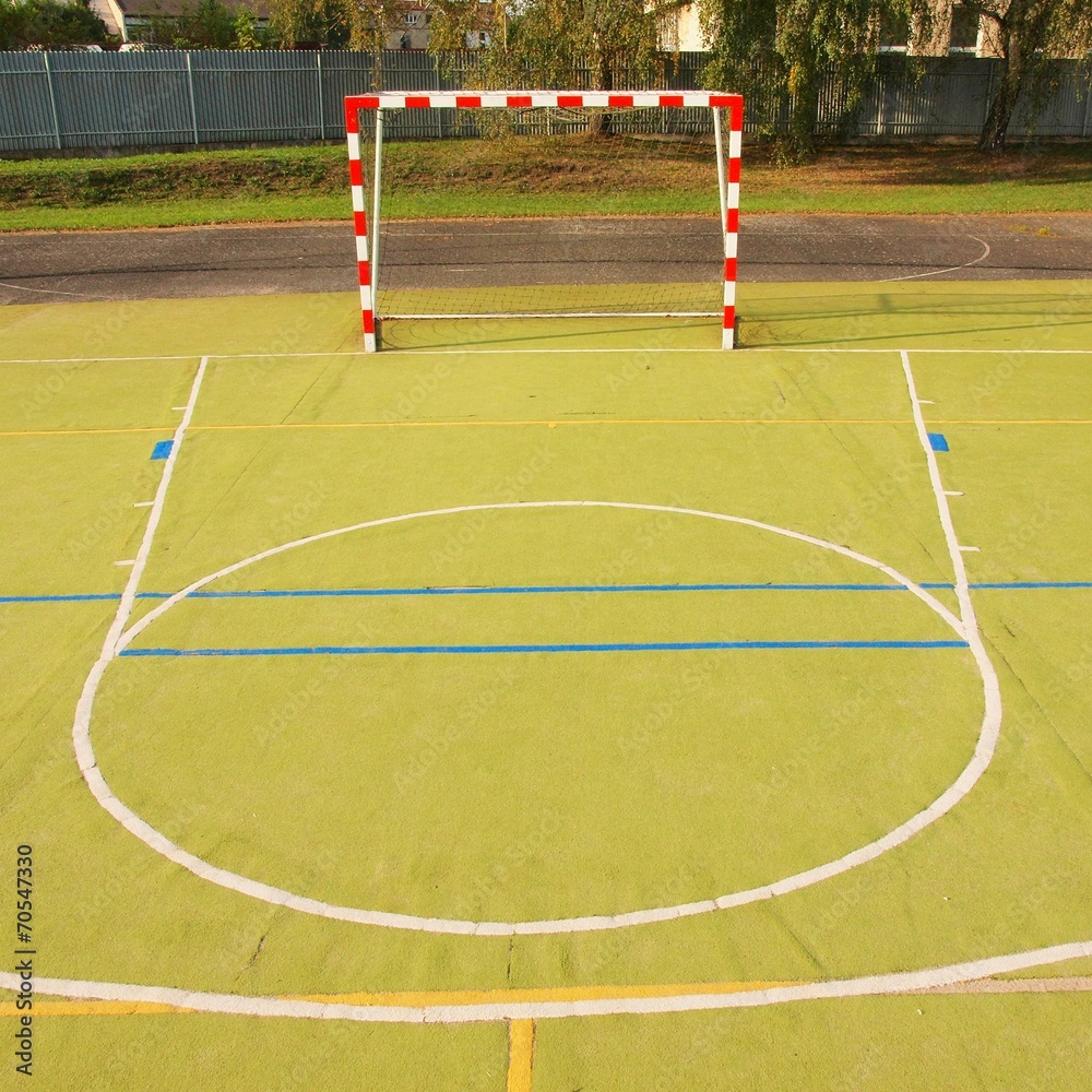 Obraz premium Empty outdoor handball playground, plastic light green surface