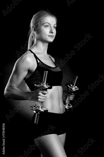 Sexy and fit woman lifting hand weights