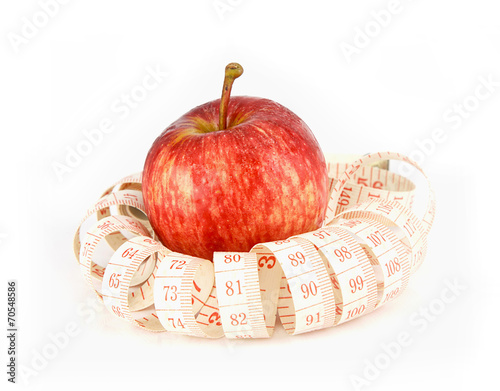 fresh red juicy apples fruit and measure tape on white backgr