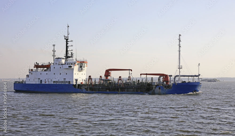dredging vessel sails on the sea
