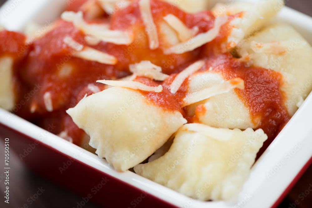 Cheese ravioli with tomato sauce and parmesan, close-up Cheese ravioli with tomato sauce and parmesan, close-up
