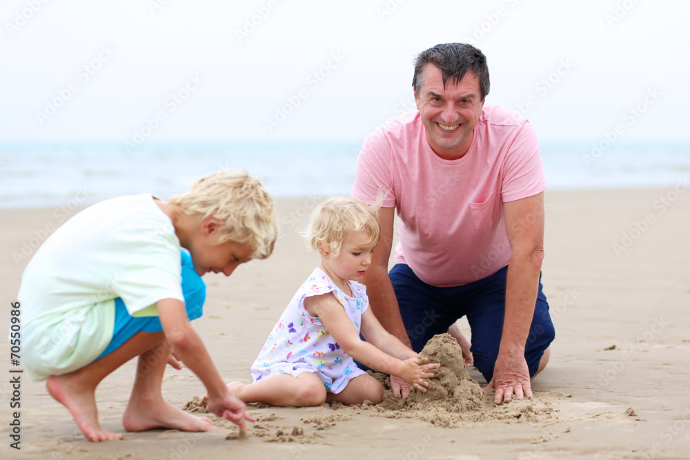 Father with kids having fun on the beach Father with kids having fun on the beach
