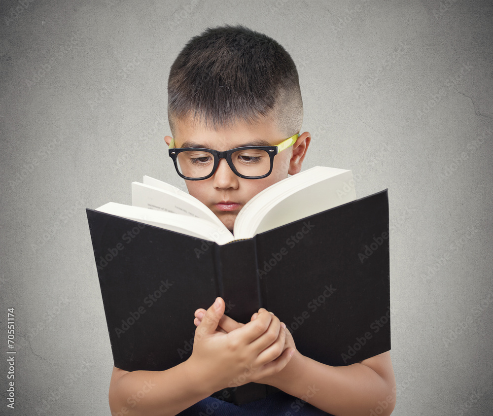 child with glasses reading book isolated grey background child with glasses reading book isolated grey background