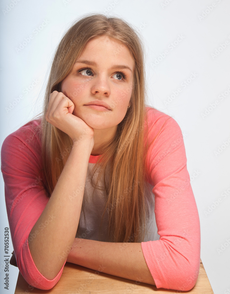 Scandinavian cute young girl portrait with head in one hand look Scandinavian cute young girl portrait with head in one hand look