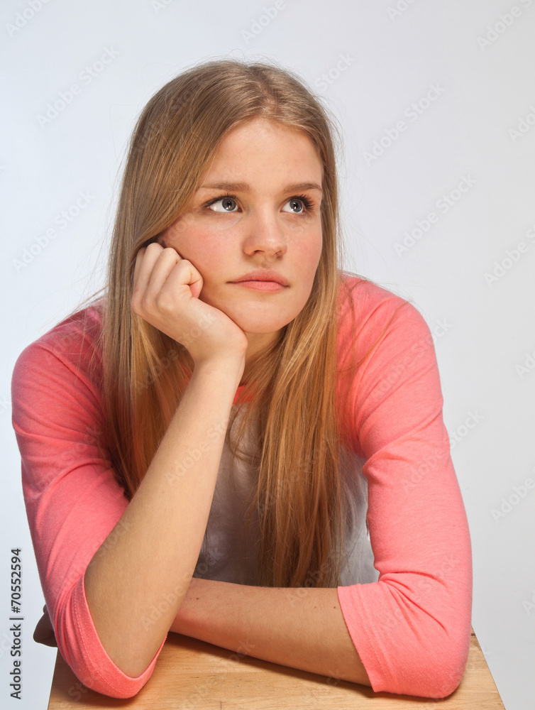 Scandinavian cute young girl portrait with head in one hand look Scandinavian cute young girl portrait with head in one hand look