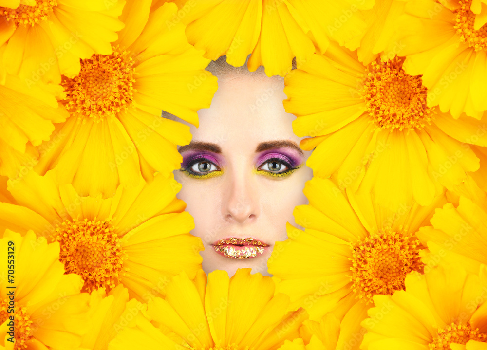 Woman beauty face with yellow flowers frame, close-up Woman beauty face with yellow flowers frame, close-up
