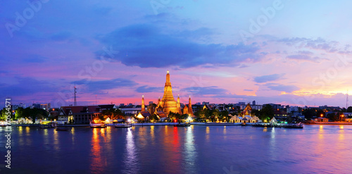 Twilight time of Wat Arun across ChaoPhraya River during sunset