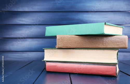 Books on dark blue wooden background