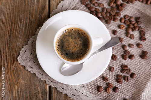 Cup of coffee with milk and coffee beans