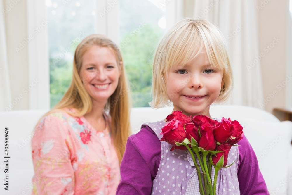 Happy woman holding red roses with daughter Happy woman holding red roses with daughter