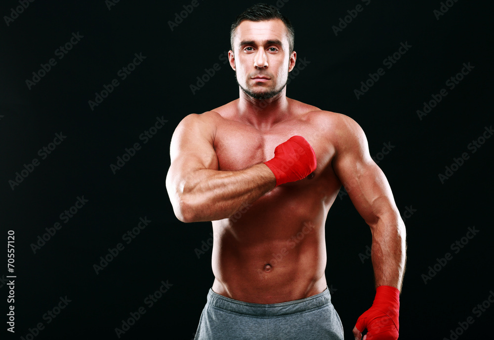 Portrait of a muscular sportsman on black background