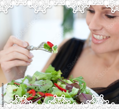 Close up of a smiling woman eating a salad photo