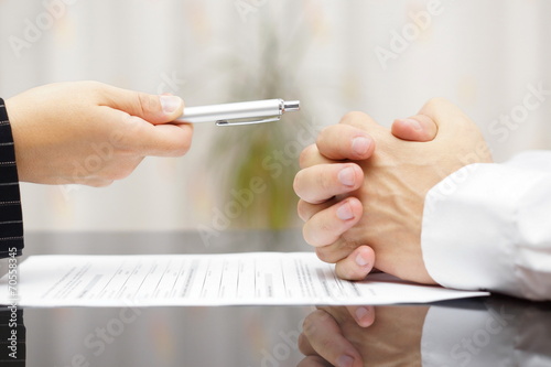 man refusing to sign a document