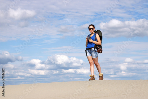 girl with camera hiking in desert