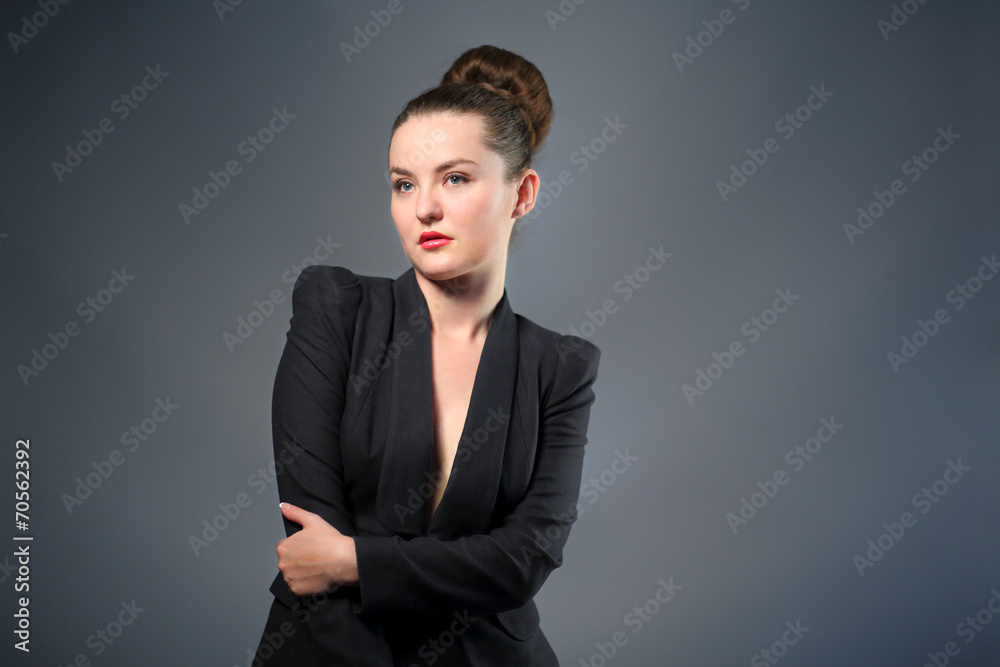 woman in black jacket stands quietly with her hands clasped woman in black jacket stands quietly with her hands clasped