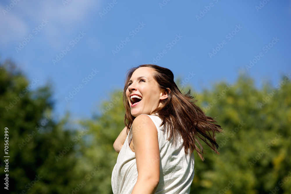Attractive woman laughing outdoors